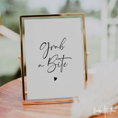 a card and gift box sitting on top of a wooden table