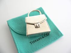 Overview:Looking for a unique gift for that special person in your life - perhaps someone who loves handbags / purses / shopping / or just anyone who enjoys the finer things in life? Here is a Tiffany piece that would be perfect for that person who has everything! Offered for sale is a rarely seen vintage Tiffany and Co. Sterling Silver Purse Pill box/case. A very cool and unique silver item. It will certainly make your friends ask "Where did you get that fabulous item?". It's like jewelry for y Gift Box Bag With Original Box In Pouch Shape, Designer Compact Gift Bags, Designer Compact Bags For Gifts, Rectangular Box Bag For Gifts, Compact Designer Gift Bags, Compact Designer Bags For Gifts, Luxury Rectangular Case Bag As Gift, Luxury Top Handle Box Bag For Gift, Designer Pouch Box Bag For Gifts