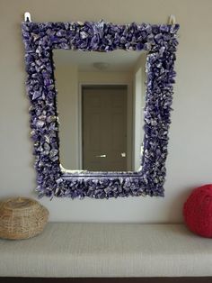 a mirror sitting on top of a wooden bench