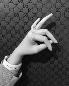 a person's hand holding up the middle finger of a gucci logo wallpaper