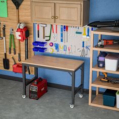 there is a workbench with tools on the wall and shelves in front of it