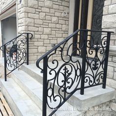 an iron railing on the front steps of a house