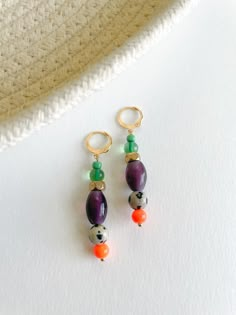 Add a burst of color to your collection with the Mecca Earrings. These vibrant earrings feature a delightful mix of various glass beads, lampwork beads, and brass accents, meticulously crafted to create a playful and unique accessory. Diverse Bead Composition: Each earring boasts a lively blend of various glass beads and lampwork beads, creating a colorful and dynamic design. Brass Accents: Delicate brass details add a touch of sophistication, enhancing the overall bohemian charm. Lever Back Earring Posts: Designed for comfort and security, ensuring a worry-free and enjoyable wear. Statement Length: These earrings measure 2 inches, making them a versatile and eye-catching addition to your jewelry collection. Materials: Various glass beads, lampwork beads, brass accents, lever back earring Bohemian Multicolor Czech Glass Earrings, Multicolor Glass Bohemian Earrings, Multicolor Bohemian Glass Earrings, Bohemian Multicolor Glass Earrings, Multicolor Czech Glass Drop Earrings, Unique Czech Glass Beaded Earrings, Handmade Multicolor Glass Earrings, Unique Beaded Earrings With Czech Glass, Green Czech Glass Earrings With Colorful Beads