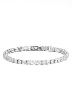 Prong-set round cubic zirconia illuminate a sparkly tennis bracelet that's perfect to stack or wear solo. 7" length; 2" extender; 1/8" width Fold-over clasp 14k-gold layer or platinum layer/cubic zirconia Imported White Sparkling Cubic Zirconia Tennis Bracelet, Sparkling Cubic Zirconia Round Tennis Bracelet, Sparkling Crystal Tennis Bracelet, Tennis Bracelet, Womens Jewelry Bracelets, Prong Setting, Cubic Zirconia, Platinum, Silver Tone