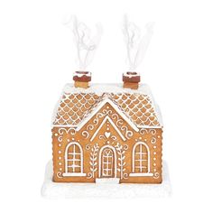 a gingerbread house with two windows and white icing on it's roof