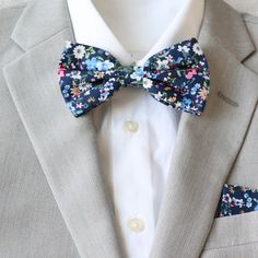 Bristol Collection includes the following:  adult skinny necktie, adult & kids pre-tied bow ties, and matching pocket squares.                                                                                            FREE swatches of this collection is available upon request.                                Color:  Blue Floral Material:  Cotton                                                                                                                         Adult Skinny Necktie:  approx. 2. Classic Blue Tie With Butterfly Knot, Elegant Spring Bow Tie As A Gift, Summer Blue Bow Tie Suit Accessories, Summer Blue Bow Tie And Suit Accessories, Elegant Spring Bow Tie For Gift, Summer Blue Bow Tie And Accessories, Dapper Blue Bow Tie For Summer, Dapper Blue Tie As Gift, Dapper Blue Tie For Gift