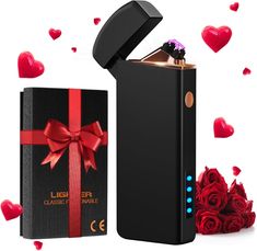 a black lighter with a red bow and rose petals around it next to a valentine's gift box