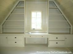 an attic bedroom with built in shelves and drawers