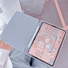 a person holding an ipad in their hand with a case on the other side of them