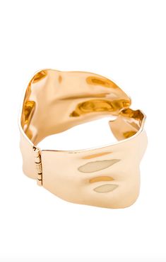 The Abstract Textured Cuff Bracelet in Gold is a must-have for the modern woman who exudes elegance and grace. Crafted with a touch of magic, these bracelets effortlessly elevate any outfit, adding a golden glow to your wrist. Embrace your inner goddess and shine with confidence. And layer it up. These bracelets were made for it. 18k gold-plated steel Hinge closure Textured effect Measures approx 2.4" in diameter Steel base: Provides durability and strength Timeless Bangle Bracelets For Party, Chic Evening Bracelets, Chic Formal Bracelets With Oyster Detail, Adjustable Yellow Gold Bracelets For Evening, Luxury Cuff Bracelet With Oyster Detail, Chic Yellow Gold Bracelets For Party, Elegant Rose Gold Cuff Bracelet For Formal Occasions, Adjustable Gold Bracelets For Evening, Elegant Adjustable Bracelet With Shiny Finish