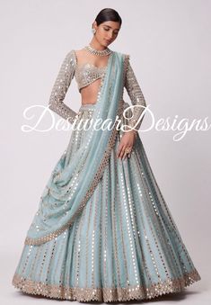 Made to Order/Measurement/Custom Order Lehenga - Color : sku blue - Fabric : Embroidered Net - Fully flared paneled lehenga - Embroidered  Blouse -  Net Dupatta with Gold Border - Drawstring closure with Tassels - - It can be customize in any design or size  PLEASE NOTE: BUYERS ARE RESPONSIBLE FOR ANY CUSTOMS AND IMPORT TAXES THAT MAY APPLY. This is a made to order product. If you opt for 'Made To Measurement Option', we will provide a measurement template and you can share the measurements likewise. If you want to opt for 'Standard Size', Please refer to the size chart provided in the listing. Shipping: Standard Shipping is done by DHL ecommerce and it mostly takes 2 to 3 weeks to deliver after dispatch. Express Shipping is done by DHL express and it mostly delivers within a week after di Floor-length Sharara With Dupatta For Ceremony, Bollywood Style Floor-length Anarkali Set For Ceremony, Fitted Pre-draped Saree With Zari Work For Wedding, Traditional Drape Gown For Wedding Festivals, Wedding Gown With Mirror Work, Floor-length, Floor-length Wedding Gown With Mirror Work, Floor-length Choli With Sheer Dupatta For Wedding, Floor-length Lehenga With Dupatta For Wedding, Gown With Dupatta In Saree Style For Ceremony