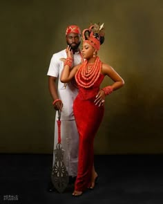 a man and woman dressed in african clothing