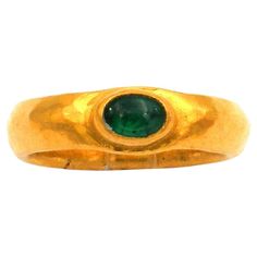 Gurhan Rune Collection 24K Gold Hand-forged Emerald Band Ring USA 1990s Sporty, elegant emerald ring, a unique piece by award-winning New York jewelry designer Gurhan Orhan, hand-forged from pure, 24-carat fine gold, set with an oval, vibrant green emerald cabochon. Gurhan Orhan (*Ankara, 1954), an award-winning goldsmith of Turkish origin from New York, has sparked a revival of fine-gold jewelry with his iconic jewelry creations. 24K yellow gold hand forged 1 emerald cabochon, 0.2 ct Band width Antique Gold Rings With Emerald, Vintage Gold May Birthstone Ring, Collectible Gold Emerald Gemstone Ring, Collectible Gold Emerald Ring With Gemstone, Gold Emerald Ring Collectible, Classic Gold Emerald Ring Collectible, Classic Gold Emerald Ring For Collectors, Antique Gold Emerald Ring For May Birthstone, Byzantine Style Yellow Gold Emerald Ring For Anniversary