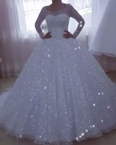 a woman in a white wedding dress posing for the camera