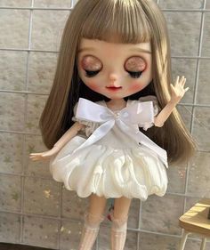 a close up of a doll wearing a dress