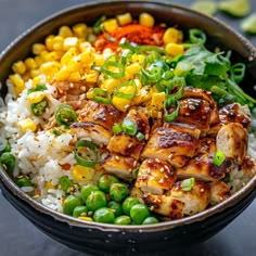 a bowl filled with rice, chicken and vegetables