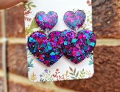 These absolute beautiful heart earrings are a real unique head Turner!  With a beautiful shimmer of electric blue and pink glitter tones these truly are a unique piece to add sparkle to any occasion or outfit ✨️ Please do check out our video 📹 A perfect gift for a loved one or friend or a great treat for yourself  Custom colour requests available! Please just send us a message with your requirements ☺️  We ship also worldwide Blue Earrings For Valentine's Day Party, Blue Heart-shaped Earrings For Party, Purple Earrings For Valentine's Day Party, Handmade Iridescent Jewelry For Valentine's Day, Handmade Double Heart Earrings For Party, Trendy Heart-shaped Birthday Earrings, Trendy Heart-shaped Earrings For Birthday, Trendy Heart Earrings For Birthday, Glamorous Handmade Earrings For Gift