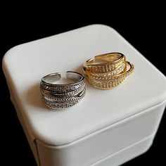 ✦ Indulge in the elegant allure of our Dainty Multi-Layer CZ Ring. This exquisite cocktail ring features multiple layers of sparkling CZ (Cubic Zirconia) stones, creating a captivating and glamorous look. Available in both gold and silver finishes, this ring offers versatility to suit your personal style. Its dainty design adds a touch of sophistication, making it perfect for special occasions or adding a touch of glamour to your everyday attire. Elevate your jewelry collection with our Dainty M Wide Ring, Wide Rings, Glamorous Look, Cz Ring, Cocktail Ring, Cocktail Rings, Multi Layering, Gold And Silver, Statement Pieces