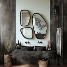 a bathroom with two sinks and mirrors on the wall