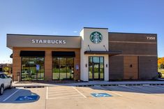 a starbucks coffee shop with a white truck parked in front