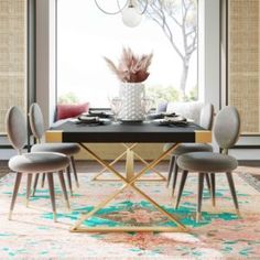 a dining room table with chairs and a vase on it