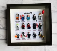 a shadow box frame with lego minifigures and the words, you are