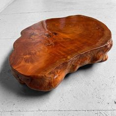 a wooden table sitting on top of a cement floor