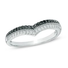 a white gold ring with black and white diamonds