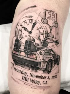 the back of a man's leg with a car and clock tattoo on it