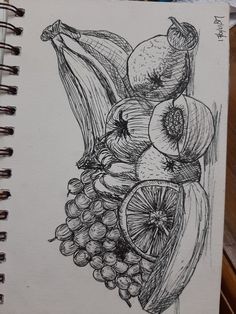 a drawing of fruit is shown on a notebook