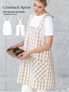 a woman wearing an apron and holding a plate with donuts on it