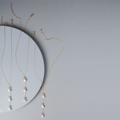 We wanted to design a non-traditional mom necklace. We chose pearls because of the natural way they're made (inside oysters) - reminds us of pregnancy. Pearls are also said to have a calming affect on the wearer and the more stress relief we can get as moms, the better. Aquamarine is our baby boy 'blue' stone for its calming properties and its link to happiness. Pink tourmaline is our baby girl 'pink' accent stone. It has positive properties of love, joy and happiness.- Y design with 3 white fre Pearl Necklaces With Natural Stones For Gifts, Pearl Necklace With Natural Stones As A Gift, Gift Pearl Necklace With Natural Stones, Pearl White Gemstone Beads Necklace As Gift, Natural Stones Pendant Pearl Necklace As Gift, Pearl Necklace With Natural Stones For Gift, Pearl Necklace With Gemstone Beads Pendant For Gift, Pearl White Gemstone Bead Necklace For Gifts, Minimalist Beaded Necklace With Pearl Drop For Gift