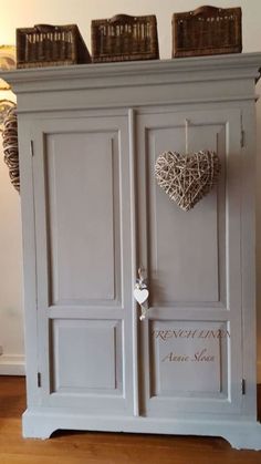 an armoire with two hearts hanging from it's sides and the words french linen