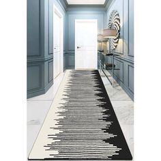 a hallway with a black and white rug on the floor