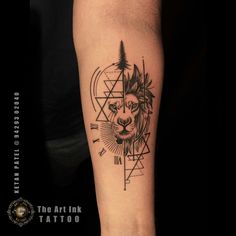 a man's arm with a tattoo on it that has a lion and triangles