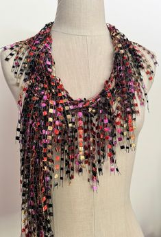 Hand knitted scarf in beautiful colors of burnt orange, satin gold, pink and raven black accented with silver metallic for the sparkle. Lot of bling with beautiful Italian ladder yarn to brighten up your outfit. Sure pop of color for any matching color outfits. Modern creative and stylish way to dress up everyday attire or add a showstopper accessory for your evening wear just by folding in half and throwing it over your shoulder and securing it with a sparkly pin. Surprise your friend or mom with something different for her special day. Great colors for fall. This is about 70"L 1"W  open traditional scarf. Hand wash in lukewarm water with mild soap, don't rub or wring, squeeze off excess water and hang to dry. Warm iron is ok if needed.  Comes with nice organza satchel for traveling or gi Handmade Black Scarf For Fall, Handmade Black Scarves For Fall, Multicolor Bohemian Scarves For Party, Handmade Black Scarves As Gifts, Black Bohemian Scarves For Festive Occasions, Black Bohemian Scarf For Festive Occasions, Multicolor Bohemian Party Scarves, Bohemian Multicolor Party Scarves, Multicolor Party Scarf One Size