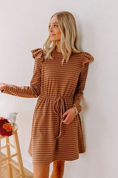 - Step out in charm with this darling mini dress! Featuring ruffled shoulders and a cinched waistline, it's perfect for effortless everyday elegance. - Unlined, ultra-soft material with a navy, sky blue, and peach colored striped pattern - A crew cut neckline - Long sleeves with ruffled shoulder details - A functional drawstring to cinch the waist - Hidden side pockets - A relaxed yet flattering silhouette that ends in a straight mini dress length hemline September Fashion, Concert Fashion, Everyday Elegance, Essential Dress, Sweater Jumpsuit, Crew Cut, Crew Cuts, Teacher Style, Striped Mini Dress