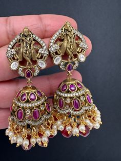 Krishna Jhumki Earrings pushback earringsColor : VictorianSize : Length : 2.5 Inches; Weight : 18grams eachStones : Red Green Stones Pearls Beads Jhumki Earrings, Traditional Earrings, Green Stones, Gold Earrings Designs, Social Events, Green Stone, Designer Earrings, Indian Jewelry, Pearl Beads