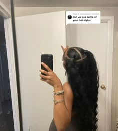 a woman taking a selfie in front of a mirror with her hair styled into a pony tail