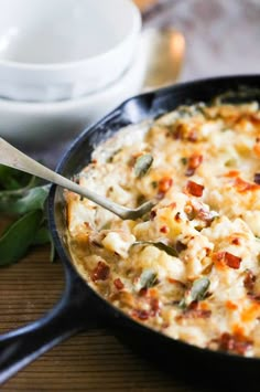 a close up of a casserole on a table with a spoon in it