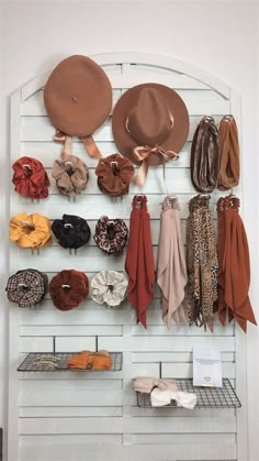 hats and scarves are hanging on the wall