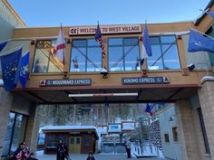 the entrance to west village is decorated with flags