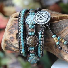 the bracelets are decorated with turquoise beads and silver charms, which have a skull on them