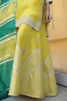 Lime yellow kurta in organza base with embroidery details. Paired with a matching chanderi sharara pant and a leheriya dupatta.
Components: 3
Pattern: Embroidered
Type Of Work: Zari
Neckline: Notched
Sleeve Type: Three-quarter
Fabric: Chanderi, Organza
Color: Yellow
Other Details: 
Attached lining
Kurta length: 38 inches
Model Height: 5ft 5inches, wearing size S
Occasion: Mehendi and Haldi - Aza Fashions Leheriya Dupatta, Yellow Kurta, Sharara Pants, Kurta Sharara Set, Kurta Sharara, Lime Yellow, Sharara Set, Types Of Work, Embroidery Details