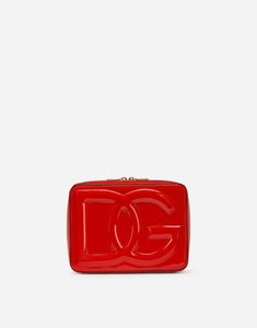 Find DOLCE & GABBANA Patent Leather Camera Bag on Editorialist. This Dolce & Gabbana camera bag is crafted from patent leather and features a logo detail. It has a zipper closure with a double branded slider. The interior is lined with calfskin and features a zipped pocket and a compartment with a strap and a press-stud button. It includes a branded dust bag. It measures 16 x 20 x 5.5 cm and is made in Italy. Designer Compact Bags For Gifts, Designer Compact Gift Bags, Compact Designer Bags For Gifts, Compact Designer Gift Bags, Designer Compact Bag With Removable Pouch, Compact Red Travel Bag, Compact Red Bags For Gifts, Designer Compact Travel Bags, Dg Logo