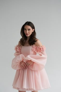 Introducing the Ariel Dress: a stunning short organza wedding dress that exudes elegance and charm. This dress features long, graceful sleeves and a boned bodice for a perfect fit, accentuated by delicate lacing at the back. The standout feature is the voluminous 3D flowers that adorn the dress, elevating it to a whole new level of sophistication. Perfect for the modern bride who wants to make a bold statement, the Ariel Dress combines timeless romance with contemporary flair, ensuring you look Elegant Organza Dress, Flower Sleeve Dress, Organza Flowers On Dress, Dress With Organza Sleeves, Dress With Flowers On It, Boning Dress, Women Birthday Dress, Short Dress Long Sleeves, Flower Dress Outfit