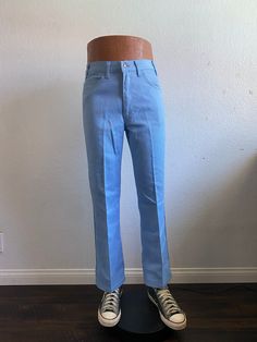 "70's Levi's Sta-Prest sky blue boot cut pants tag size 32x29. Zip fly, 50% cotton 50% polyester, good used condition, check pictures, made in U.S.A.  Please, check carefully the measurements, photos and description of the article before buying it, we do not accept changes or returns. Measurements lying face down: (mannequin is 47\" tall from the floor to the top) 16\" Waist flat face down. 40\" Outseam. 20\" Hip. 12\" Thigh. 12\" Front rise. 29\" Inseam. 9\" Leg opening. Let me know if you have any questions or would like to see additional photos. International buyers: Please ask for the shipping rates speciality for your country." Retro Blue Flare Jeans With Pockets, Fitted Wide Leg Light Blue Jeans, Retro Blue Wide Leg Jeans, Fitted Light Blue Wide Leg Jeans, High Waist Light Blue Fitted Flare Jeans, Fitted Light Blue Pants, Light Blue Fitted Wide Leg Jeans, Light Blue High Waist Fitted Flare Jeans, Fitted Full-length Light Blue Pants