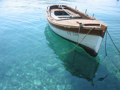 a small boat floating on top of a body of water