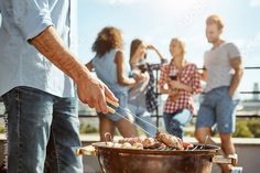 people are grilling food on an outdoor grill