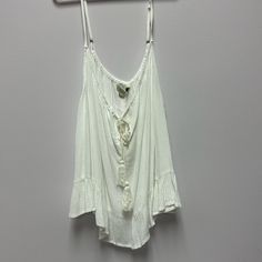 Ladies Boho Tank Top. Flowy Material, Cute Ruffle On Bottom. String Tie At Top. Size Large, Fits Smaller. Nwt Bohemian Cami Top For Vacation, White Bohemian Tank Top For Beach, White Bohemian Tank Top For Beach Season, White Bohemian Cami Top, Flowy Cami Top For Vacation, Bohemian White Cami Top, Summer Cami Blouse For Vacation, White Bohemian Tank Top For Summer, Flowy Cotton Tank Top For Beach